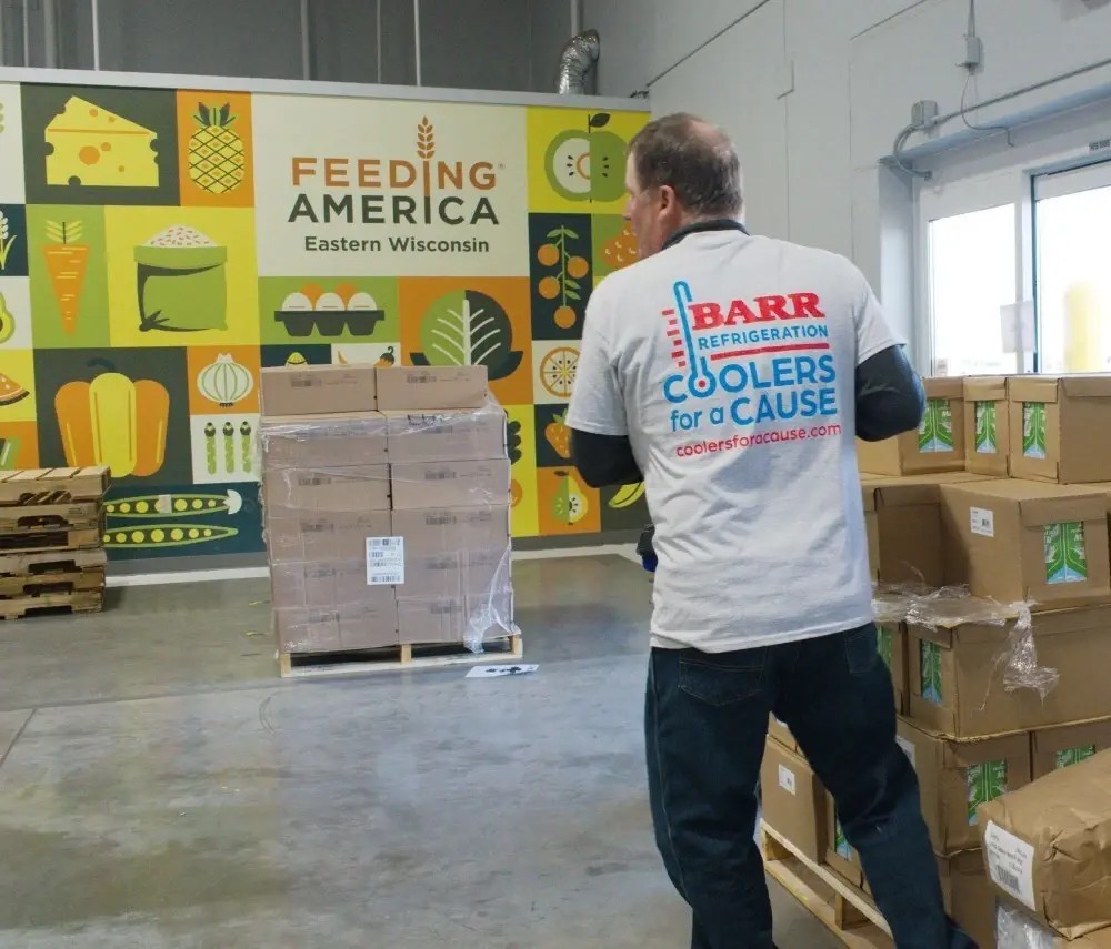 Barr Refrigeration employee Dan Mueller resupplying the food assembly line at Feeding America Eastern Wisconsin in Appleton, WI