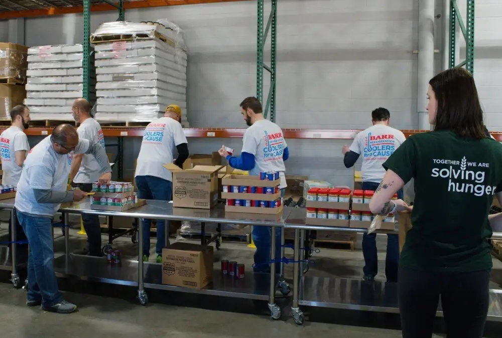 Barr Refrigeration employees packing boxes of food for senior citizens at Feeding America Eastern Wisconsin in Appleton, WI